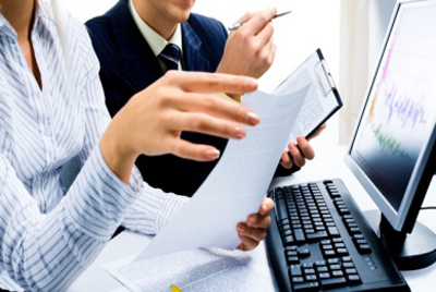 Image of two business partners discussing documents